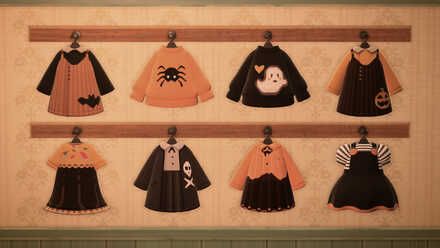 an assortment of halloween sweaters hanging on a wooden shelf in front of a wall