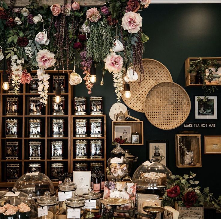 an assortment of desserts and pastries on display in a room with green walls