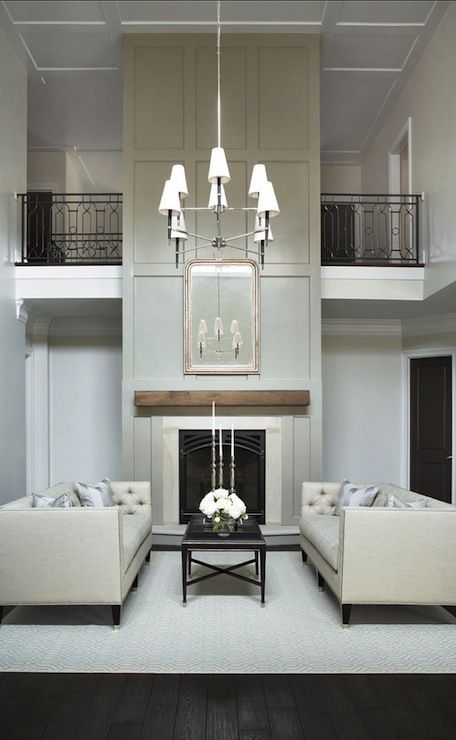 a living room filled with furniture and a fire place in the middle of a room