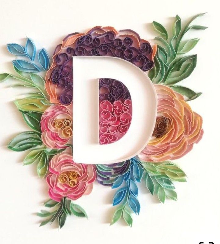 the letter d is made up of paper flowers, leaves and vines on a white background