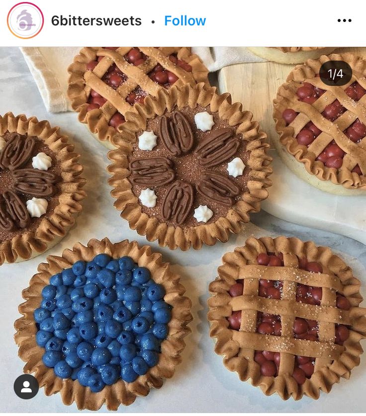 four pies with different toppings are on the table