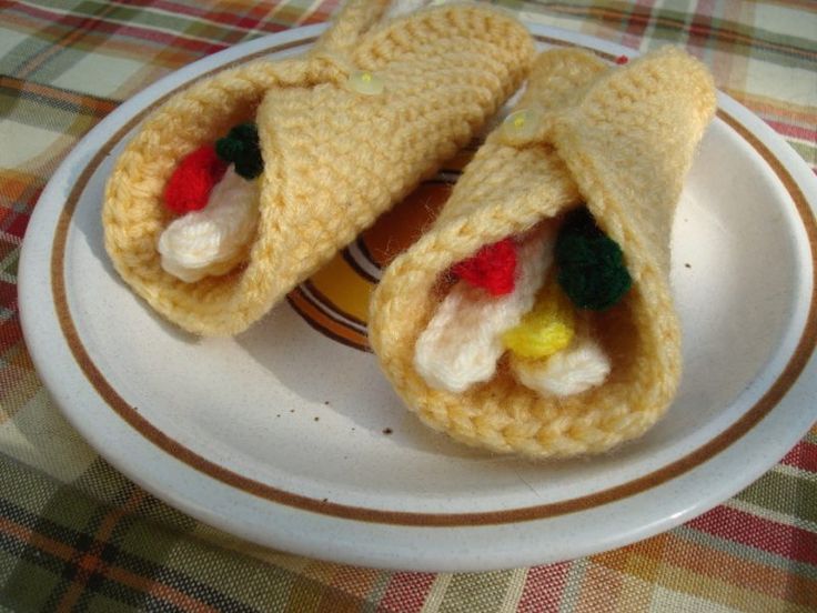 two crocheted hot dogs on a plate