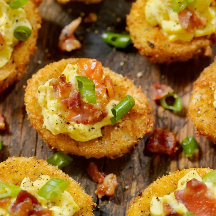 small appetizers with bacon, cheese and green peppers on a wooden table top