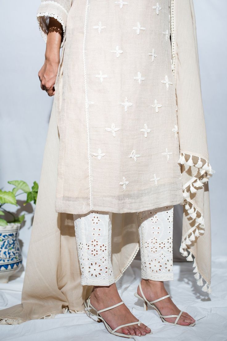 Beige cross embroidered kurta with lace work detail. Paired with schiffli pant and cotton dupatta.
Component: 3
Pattern: Embroidered
Type Of Work: Thread work
Neckline: Round
Sleeve Type: Three quarter
Fabric: Linen, Cotton
Color: Beige
Other Details: 
A line sleeves
Tassel dupatta
Occasion: Work - Aza Fashions Tassel Dupatta, Kurta Set For Women, Types Of Work, Cotton Dupatta, Thread Work, Kurta Set, Set For Women, Aza Fashion, Sleeve Type