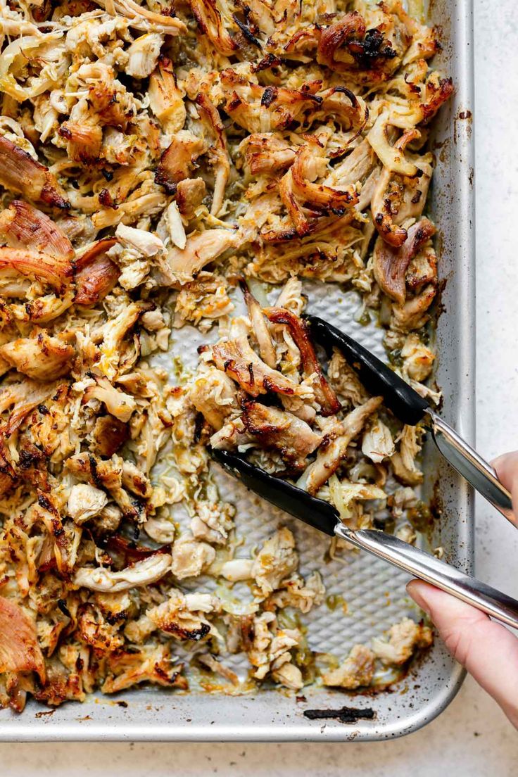 someone cutting up some food on top of a pan