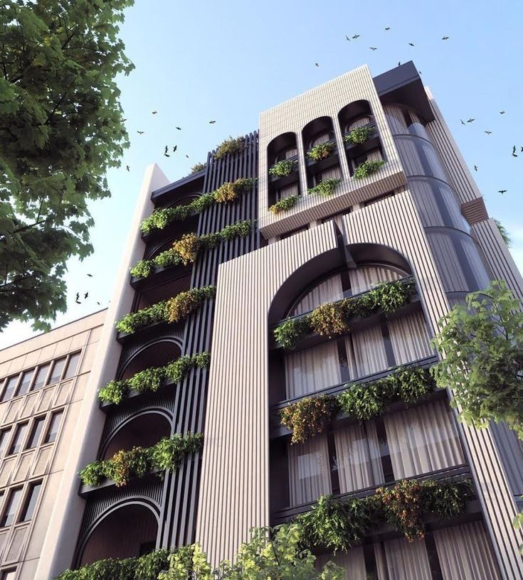 an apartment building with plants growing on the balconies