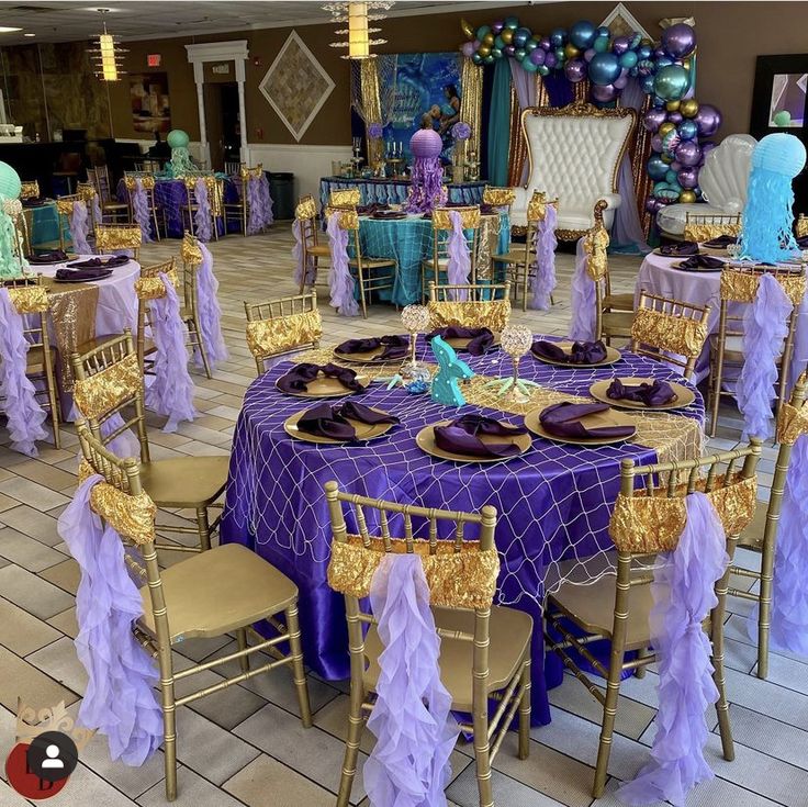 purple and gold tables are set up for a party