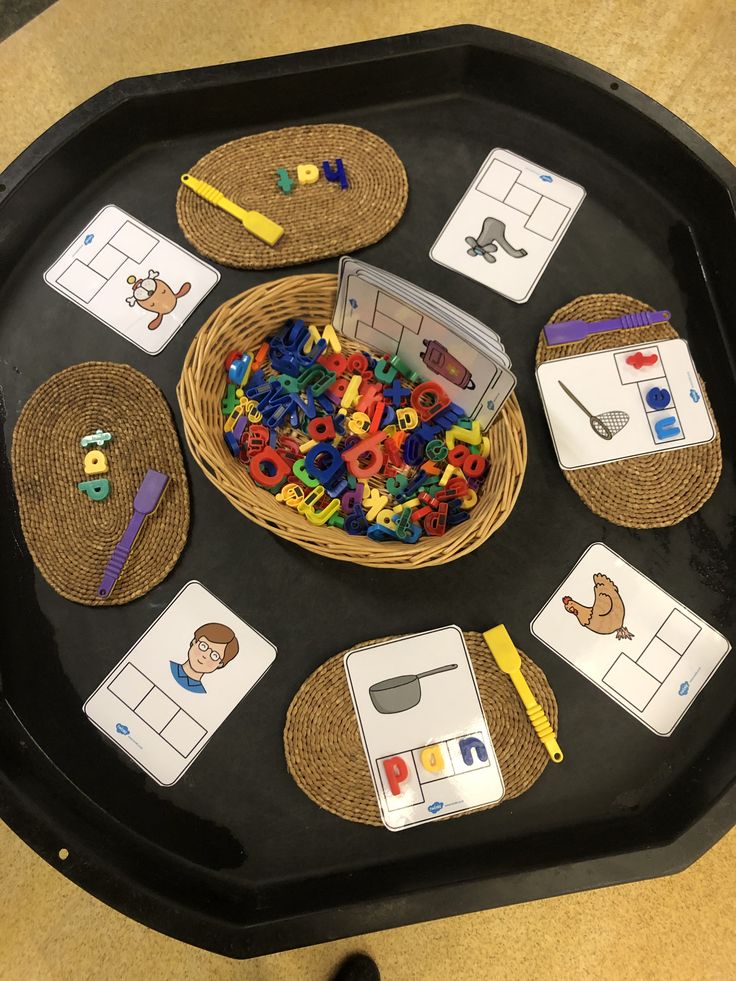 a black tray topped with lots of different types of letters and numbers on top of it