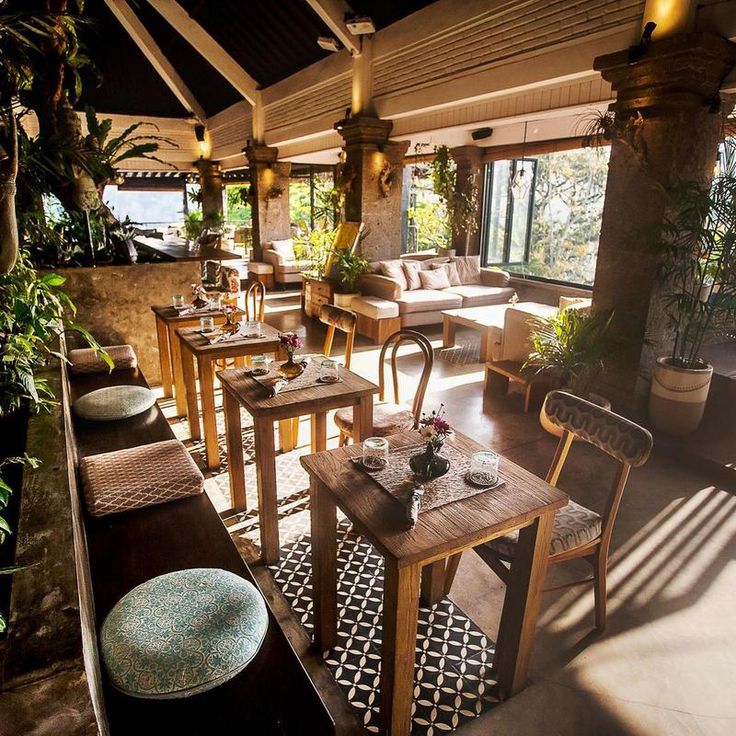 an outdoor restaurant with wooden tables and chairs