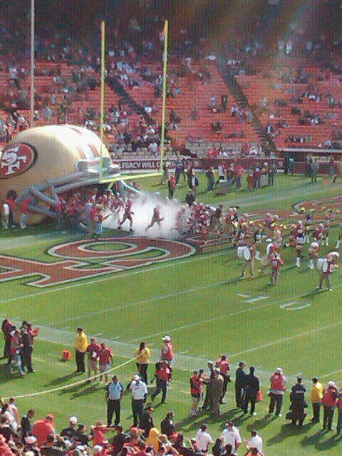 a group of people standing on top of a football field