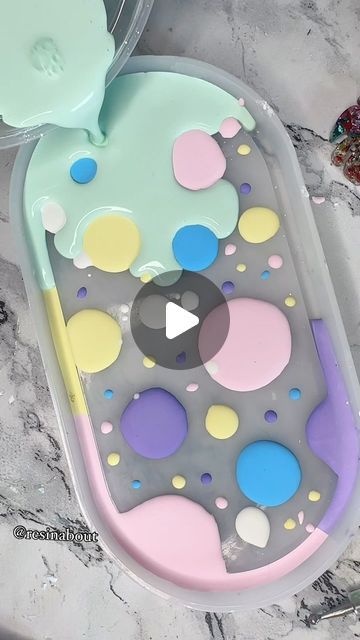 an image of a tray that is decorated with circles and dots on the bottom, as well as a spoon