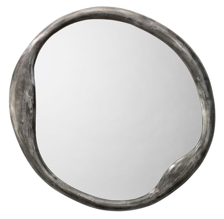 a round mirror with curved metal frame