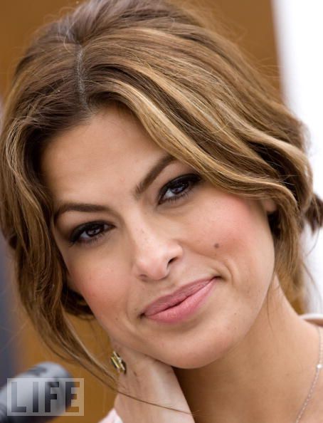 a close up of a person with a necklace on her neck and an orange lip