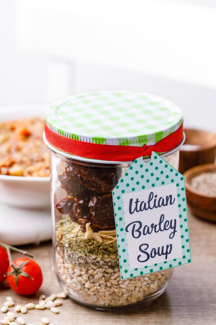 a jar filled with food sitting on top of a wooden table next to other foods