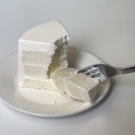 a piece of cake on a white plate with a fork in it and one slice missing