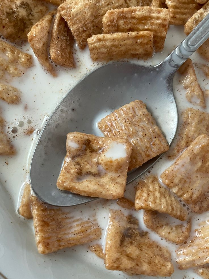 a spoon full of sugar cubes sitting on top of a white plate