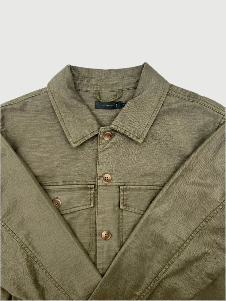 Stay warm and stylish with The Appalachian Jacket in Dusty Olive! This jacket is designed for men and features a classic collar, two front pockets on the chest, and button cuffs on the sleeves. Perfect for any outdoor adventure, this jacket is both functional and fashionable. Fit: True To Size Fabric Content: 98% organic cotton, 2% Elastane Care: Machine Wash Cold, Low Tumble Dry Khaki Outerwear With Lapel Collar And Button Cuffs, Long Sleeve Denim Jacket With Pockets For Outdoor, Solid Utility Jacket With Flap Pockets For Outdoor, Outdoor Long Sleeve Shacket With Flap Pockets, Military Style Khaki Utility Jacket With Buttoned Pockets, Rugged Long Sleeve Denim Jacket With Pockets, Outdoor Denim Jacket With Patch Pockets And Long Sleeves, Rugged Long Sleeve Sport Coat For Outdoor, Military Style Outerwear With Lapel Collar And Pockets