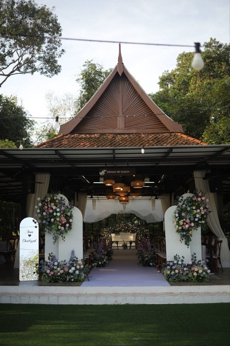 a gazebo decorated with flowers and greenery