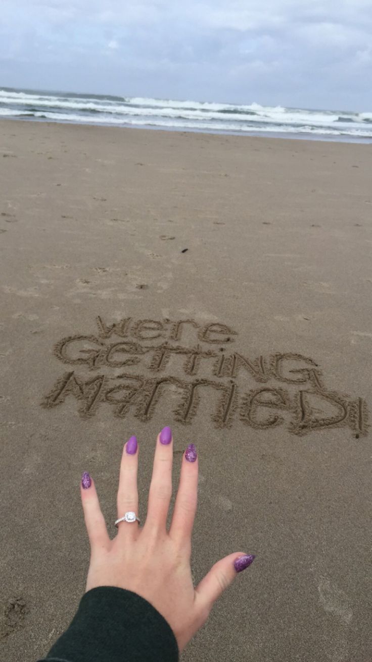 someone's hand on the beach with their fingers in the sand that says congratulations