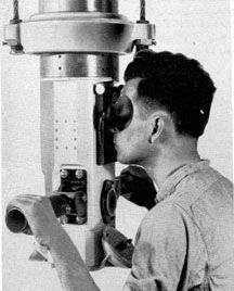 a man looking through a telescope at something