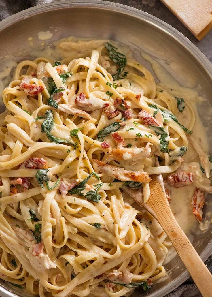 pasta with chicken and spinach in a pan