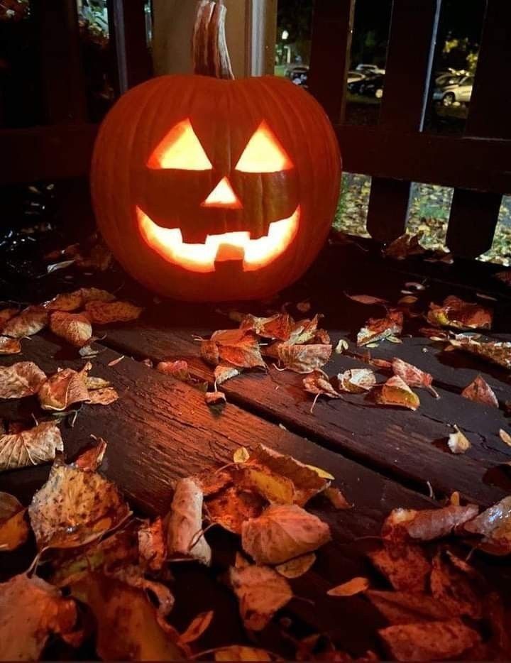 a carved pumpkin sitting on top of a wooden table