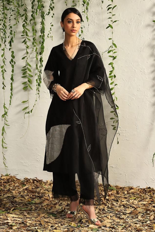 Black kurta with placement leaf embroidery and scalloped sheer panels. Paired with scalloped edge flared pant and sheer embroidered dupatta.
Components: 3
Pattern: Embroidered
Type Of Work: Nakshi, Zari, Cutdana
Neckline: Scallop
Sleeve Type: Scallop
Fabric: Kurta: Chanderi, Pant: Cotton Satin, Dupatta: Organza, Lining: Cotton
Color: Black
Other Details: 
Length:
Kurta: 45 inches
Pant: 37 inches
Dupatta (LXW): 90 X 20 inches
Occasion: Sangeet - Aza Fashions Blouse Yoke, Black Kurta, Embroidered Pants, Straight Kurta, Kurta With Pants, Kurta Designs, Kurta Set, Pants Pattern, Pant Set