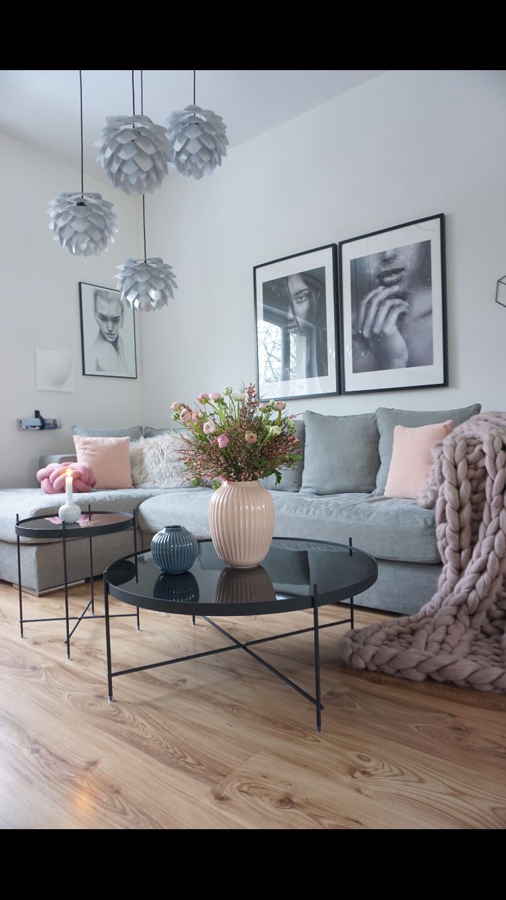 a living room filled with furniture and pictures hanging on the wall above it's coffee table