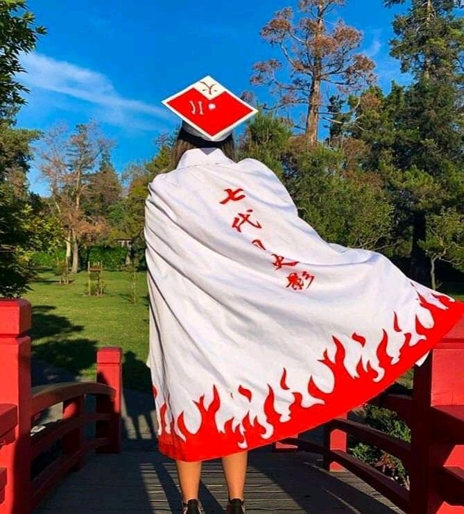 a woman is walking across a bridge with a white and red blanket on her head