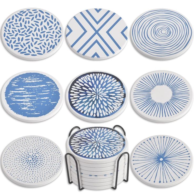 six blue and white plates with circular designs on the front, one has a metal stand