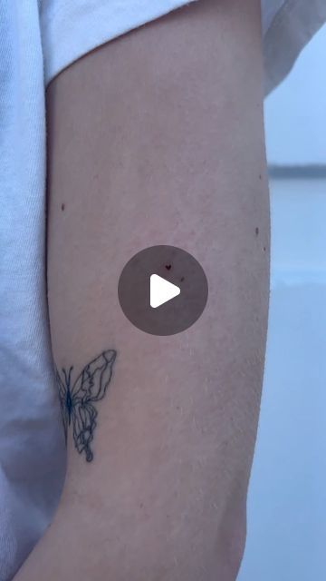 a person with a butterfly tattoo on their arm