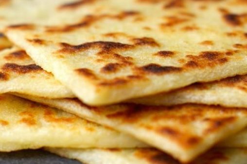 a stack of flatbreads sitting on top of a table