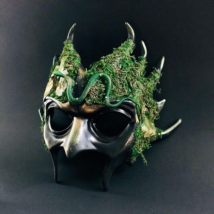 Venture into the heart of the enchanted woods with our Forest Emerald Ent Mask. Adorned with lush green moss and creeping vines, this mask embodies the spirit of ancient forest guardians, perfect for nature-themed events or mystical gatherings. Additional product details: All our masks come with Ribbons or elastic bands attached unless it’s a handheld stick mask Size/Type: One Size Fits Most Mask Color: Dark Green with Natural Accents Mask Material: High-Quality Resin and Natural Moss Accent Mat Forest Masquerade, Forest Mask, Nature Themed Masquerade Mask, Woodland Mask, Forest Spirit Mask, Kids Party Packs, Mardi Gras Kid, Creeping Vines, Female Mask