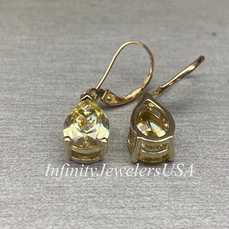 These earrings are pear shape simulated Canary yellow diamonds lever back earrings made with solid 14k yellow gold item #6843 -Approximate total carat weight: 6.00ctw -Center Stone Size: approx. 3.00ct each diamond equivalent -Gem Type: simulated diamond -Stone Shape: pear shape 12x8mm each -Stone Clarity: VVS1 -Stone Color: Canary Yellow -Metal Type and Purity: 14k yellow gold -Setting: 3 prong -Closure: lever back (earring backs are subject to change due to availability) -Country of Manufactur Gold Drop Earrings With Prong Setting, Gold Drop Diamond Earrings With Prong Setting, Yellow 14k Gold Drop Earrings, Classic Yellow Diamond Earrings, Classic Yellow Oval Earrings, Diamond Cut Pear Teardrop Earrings For Gift, Teardrop Earrings With Prong Setting For Anniversary, Gold Pear-shaped Cubic Zirconia Diamond Earrings, Yellow Diamond Drop Earrings For Gift