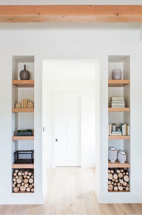 an empty room with wooden shelves and white walls