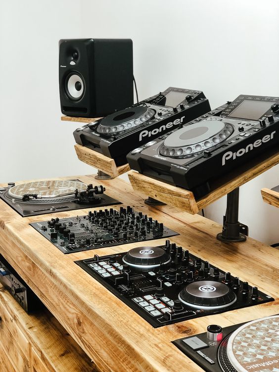 dj equipment sitting on top of a wooden table