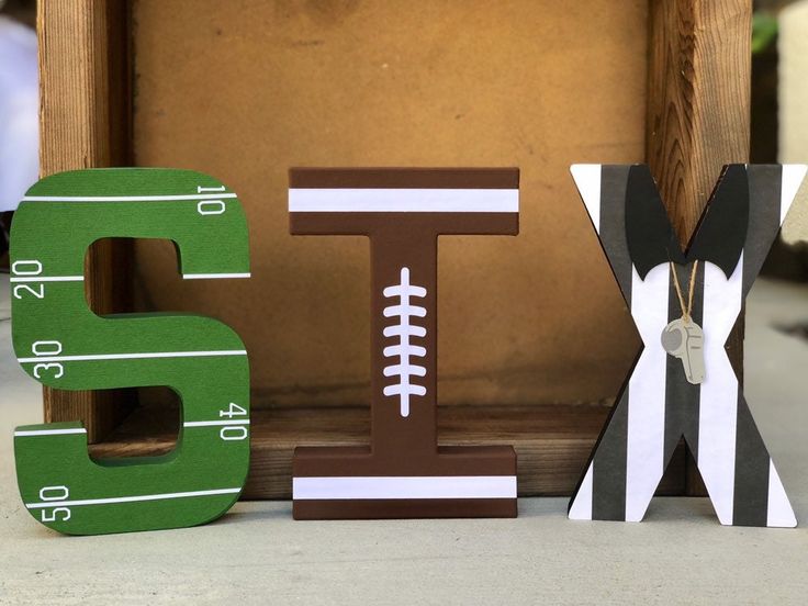 the letters are made out of wood and have footballs on them