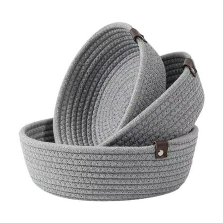 three grey baskets stacked on top of each other, one with leather handles and the other without