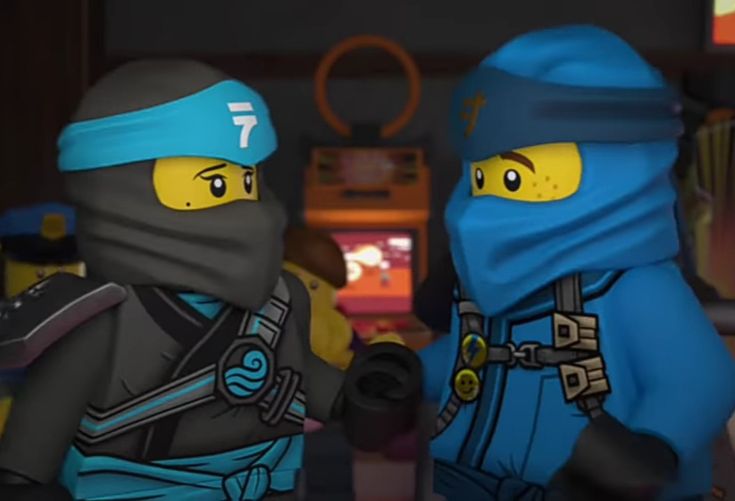 two lego ninjas are standing next to each other