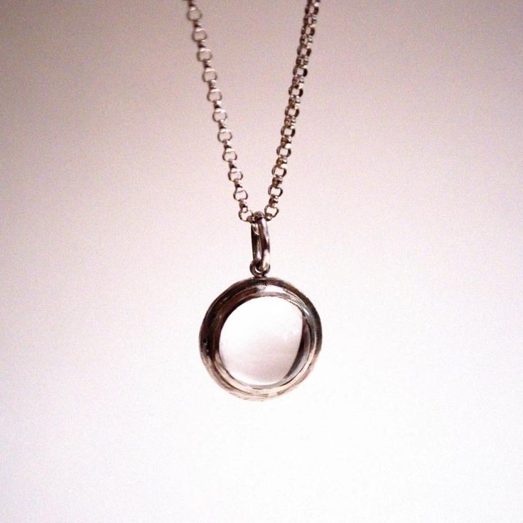 Handmade to order from sterling silver materials and set with a genuine, natural and watery clear quartz crystal ball. The sphere in this necklace measures 10mm in diameter with the bezel frame bringing the overall width to 13mm, approximately. After setting each stone, I bring the frame to a high glossy shine, and string them onto a 16-inch or 18-inch sterling silver rolo chain.The lore behind the pools of light jewelry went that each glowing crystal ball contained a tiny dancing spirit trapped Modern Circle Necklaces For Formal Occasions, Modern White Gold Necklaces With Open Circle, Modern Open Circle Necklace For Formal Occasions, Modern White Gold Necklace With Open Circle Design, Modern White Gold Open Circle Necklaces, Modern White Gold Open Circle Necklace, Glowing Crystal, Light Necklace, Light Jewelry