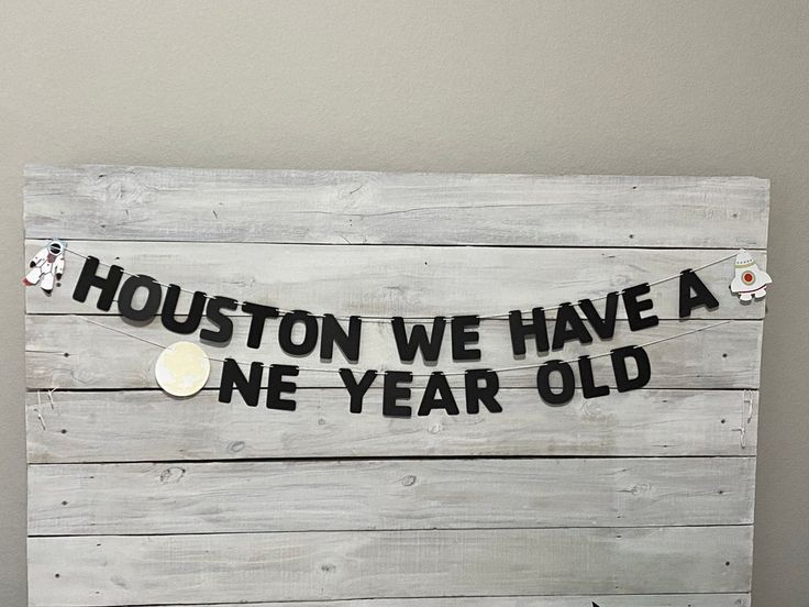 a wooden sign that says houston we have a new year old