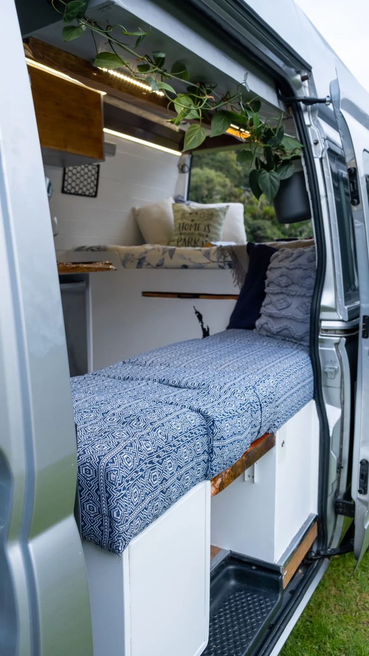 the inside of a van with its bed pulled up to it's rear door