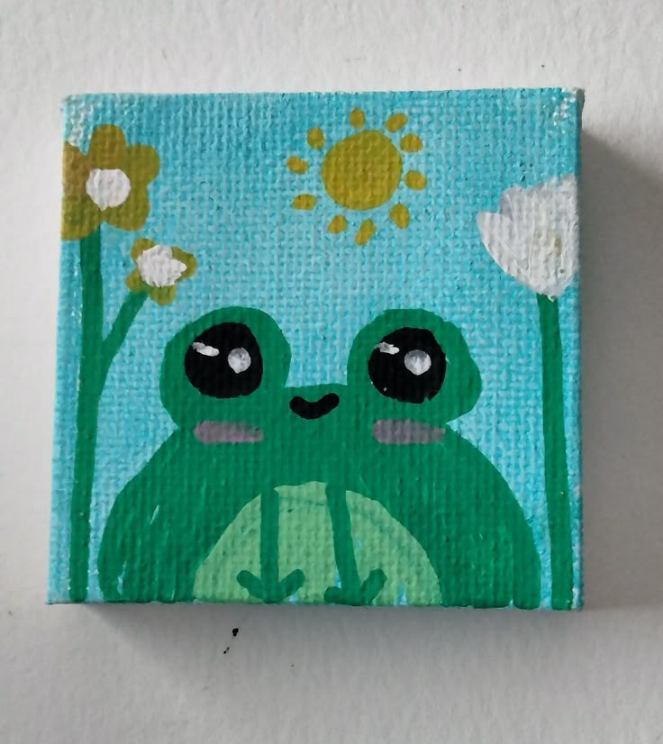 a painting of a green frog with flowers on it's head, sitting in front of a white wall