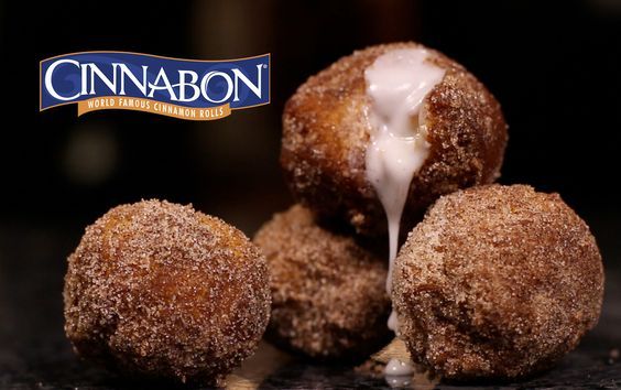 cinnamon donuts with icing drizzled over them on a counter top