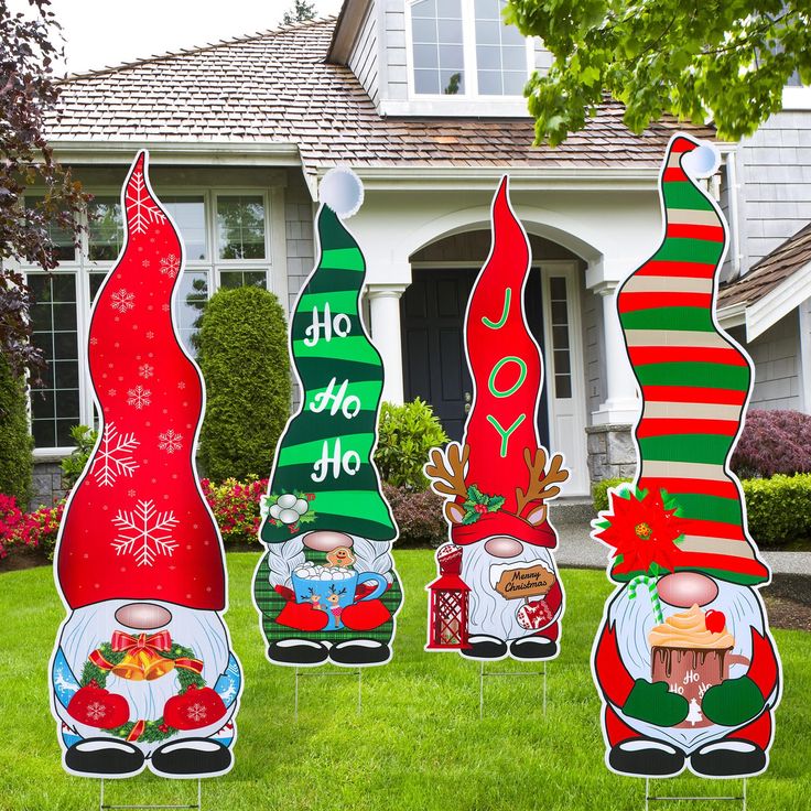 christmas yard decorations in front of a house