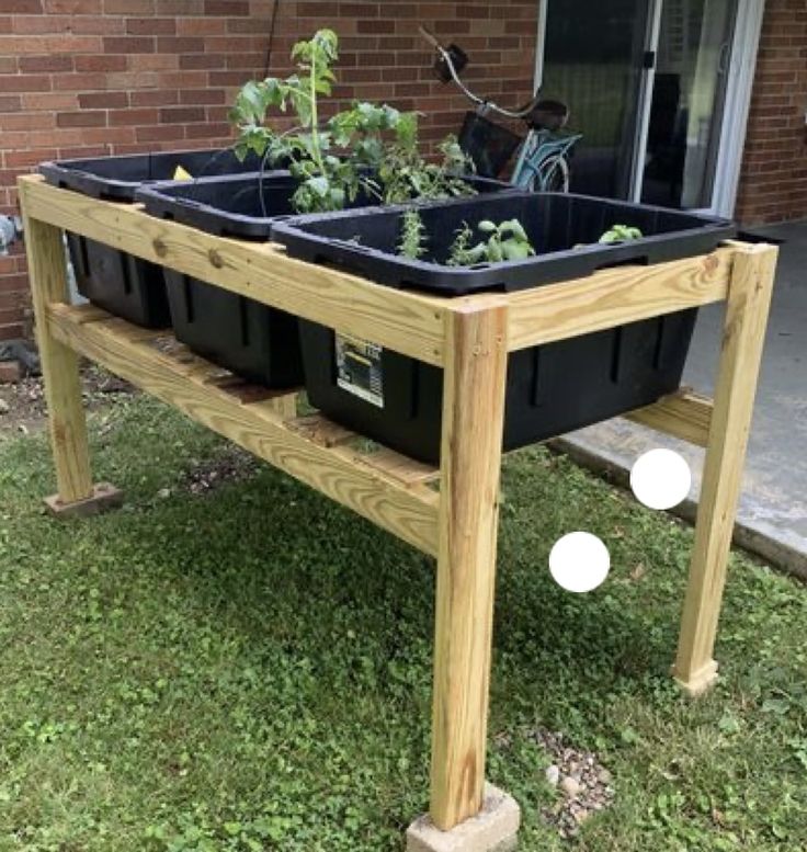 an outdoor planter with plants growing in it