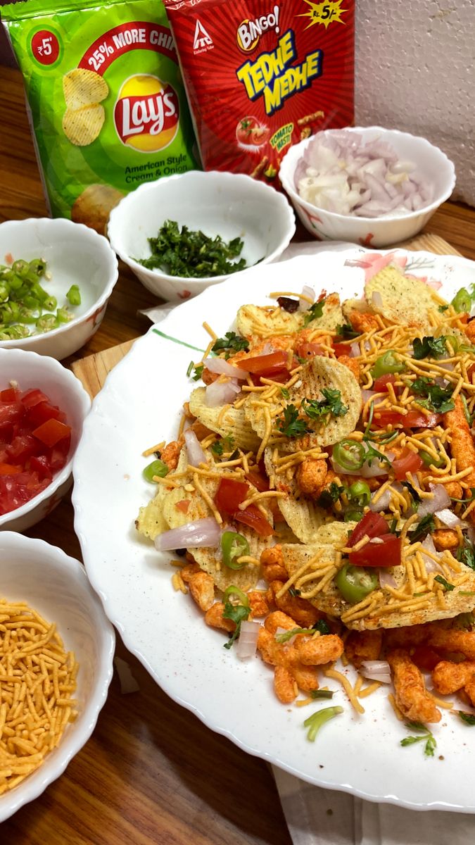 a table topped with lots of food and bowls filled with different types of toppings