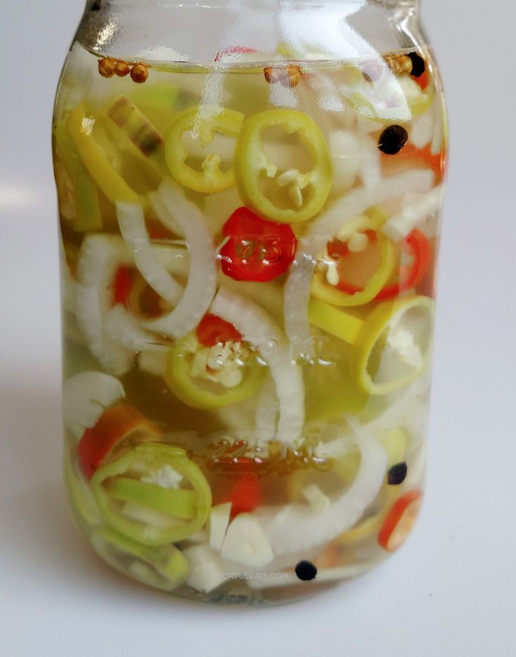 a jar filled with lots of different types of food in it's bottom half