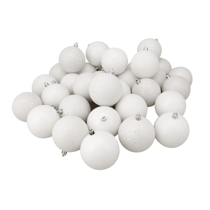 a pile of white christmas balls sitting on top of each other