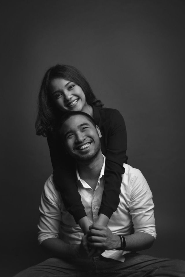 a black and white photo of a man holding a woman